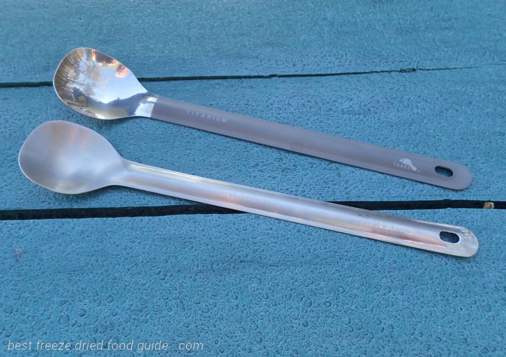 The REI and TOAKS long handle titanium camping spoon side by side